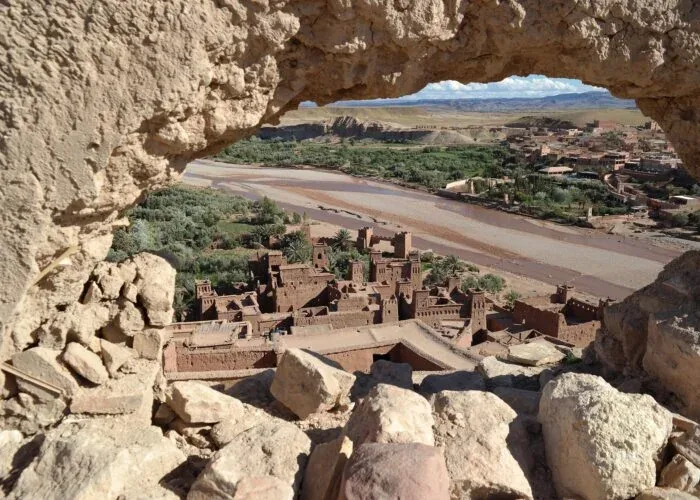 Ait Ben Haddou's earthen buildings seen through a rock opening
