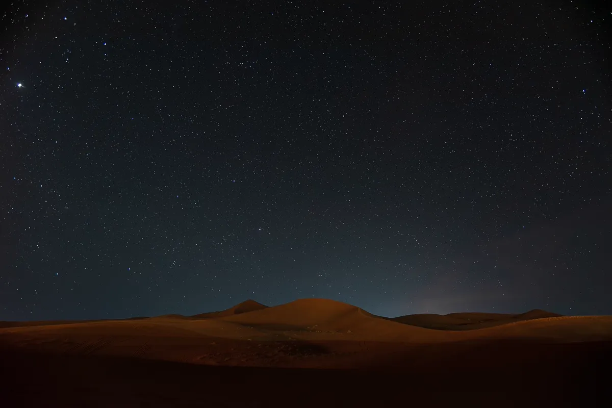 Merzouga stargazing – starry night sky over the Sahara dunes